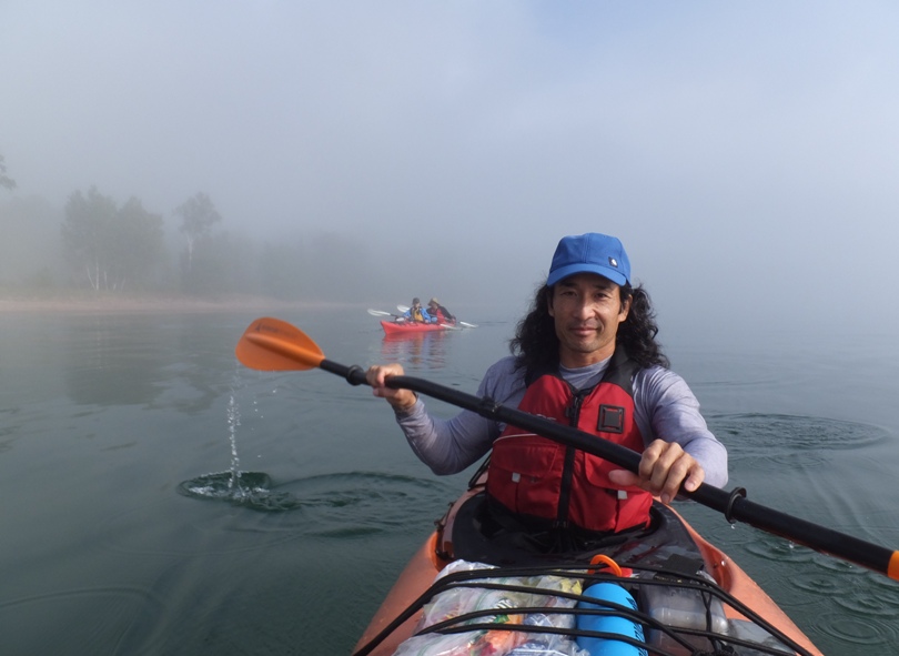 Me kayaking with a bent shaft paddle