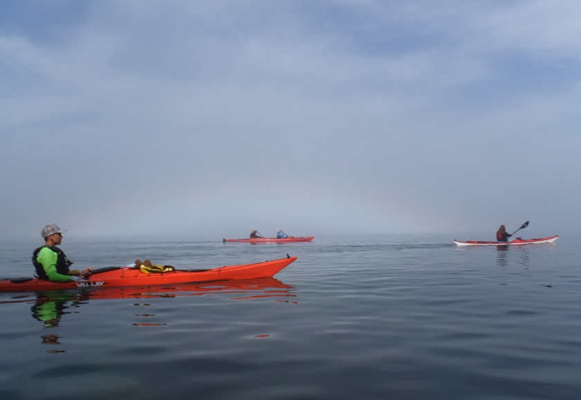 Three kayaks with fog bow barely noticeable in background