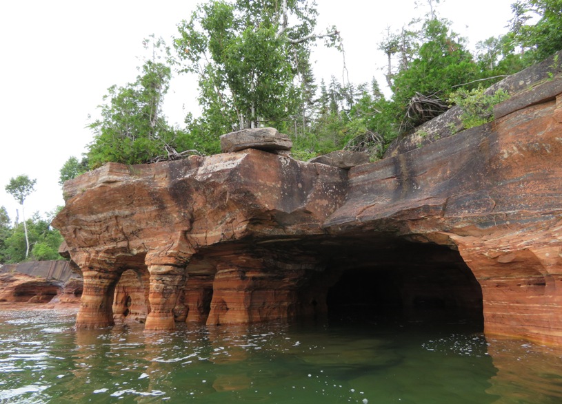 Stone columns on the left of the cave opening