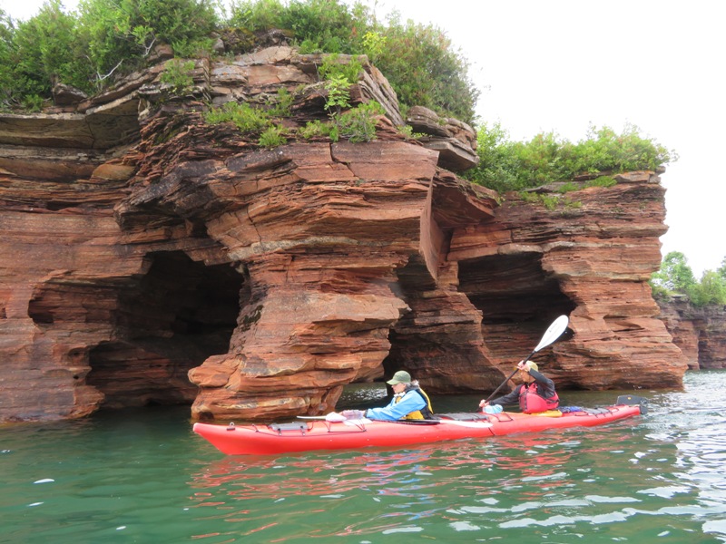 Steve paddling while Carmen tinkers with stuff on their boat