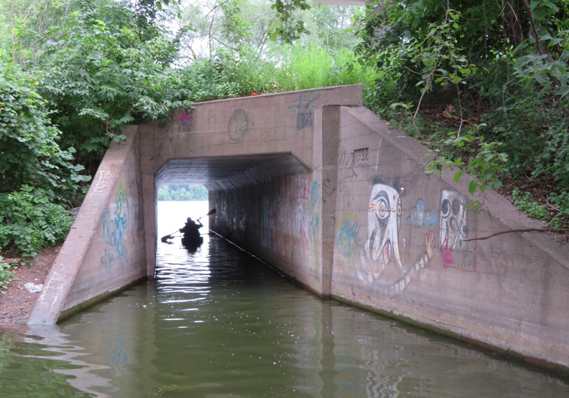 Steve and Norma kayaking through a tunnel under Cedar Lake Trail