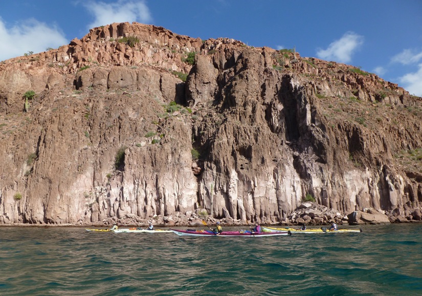 Kayakers in front of rocky view