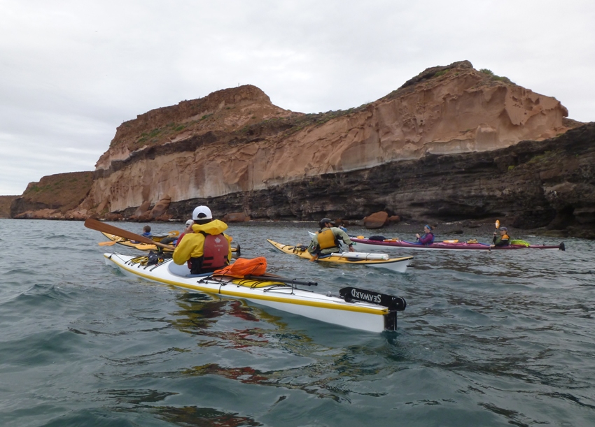 Our group on the water with big rocks behind