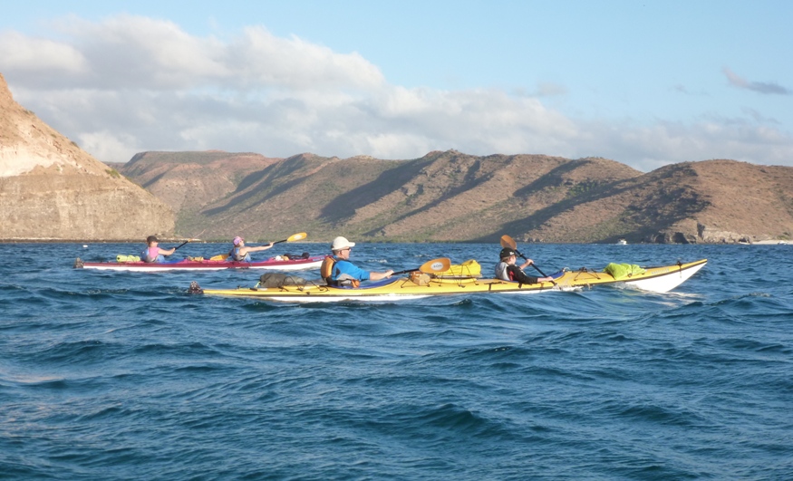 Starboard view of two tandem kayaks on water.  From left to right: Anita, Leah, Rob, and Scott