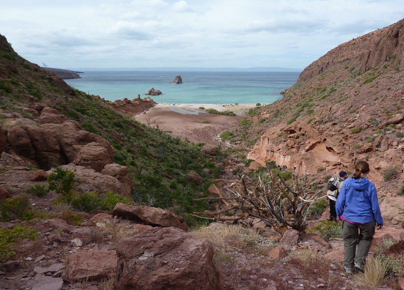 Norma walking down a rocky valley