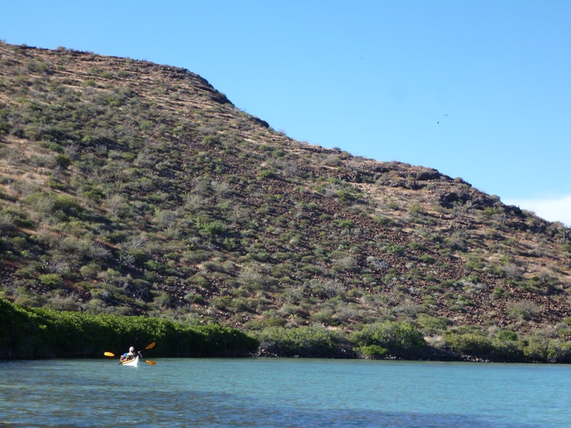 Rob and Scott on the water with a big hill behind