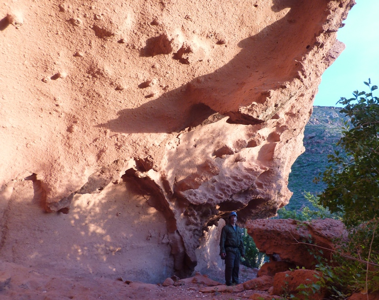 Me standing in the shade of a volcanic cliff