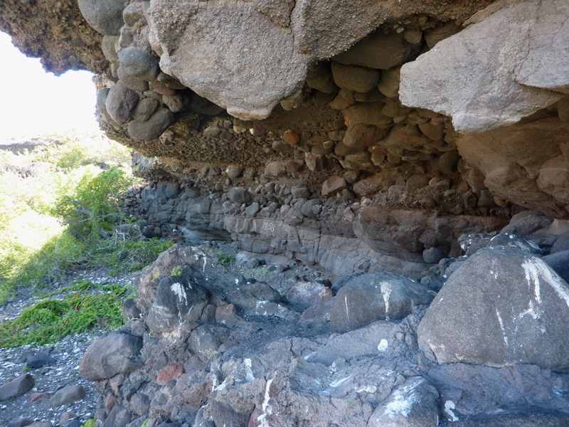 Another view of the sheltered rocky area with '1858' on the wall