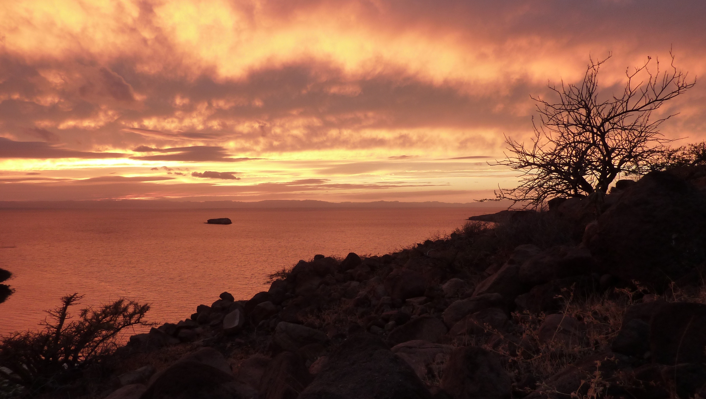 Red sky sunset on Espiritu Santo Island from a hilltop