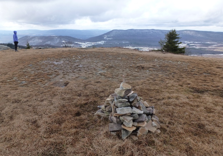 Open grassy area with Norma and a cairn