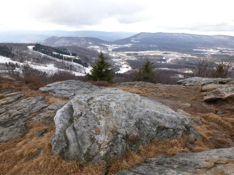 Boulder with snow in the distance