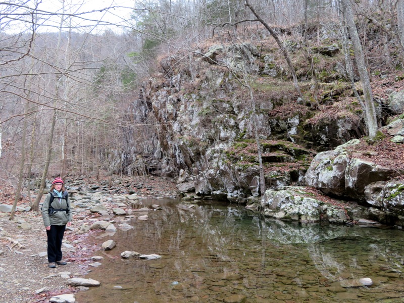 Norma standing next to rocky creek