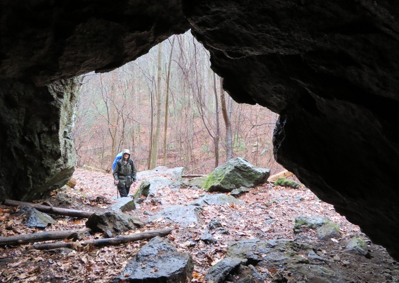 Norma standing outside the cave