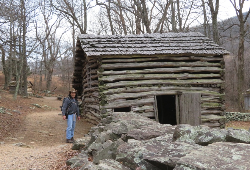 Me next to log cabin