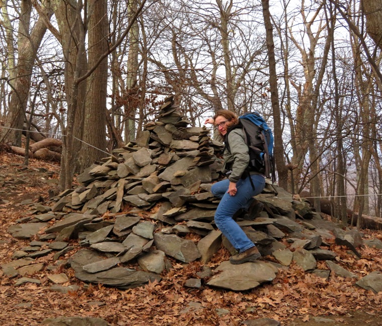 Norma adding a rock to a large cairn