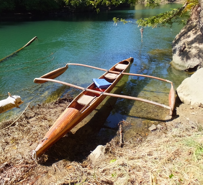 Beautiful wooden outrigger canoe at waters edge