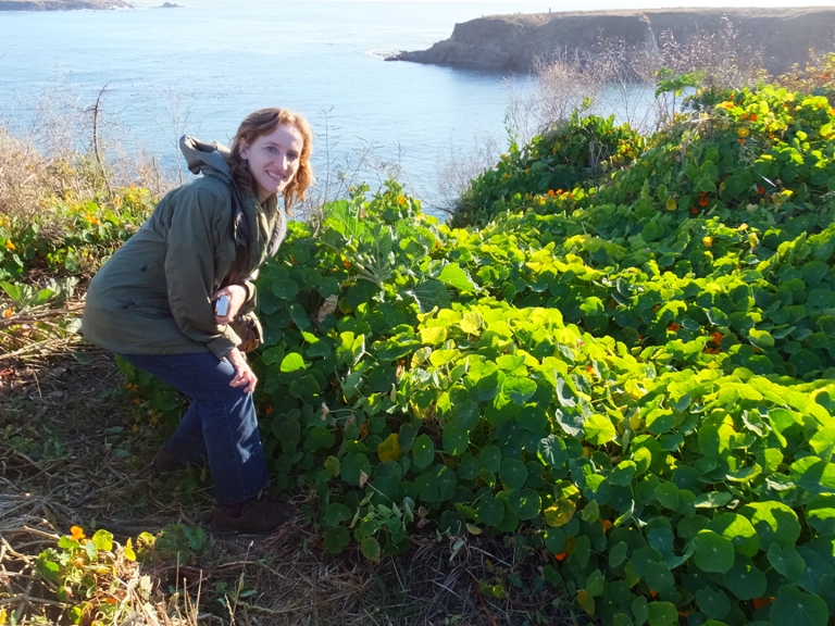 Norma with plant and ocean behind