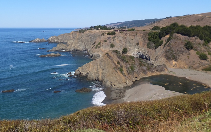 Beach by rocky cliffs