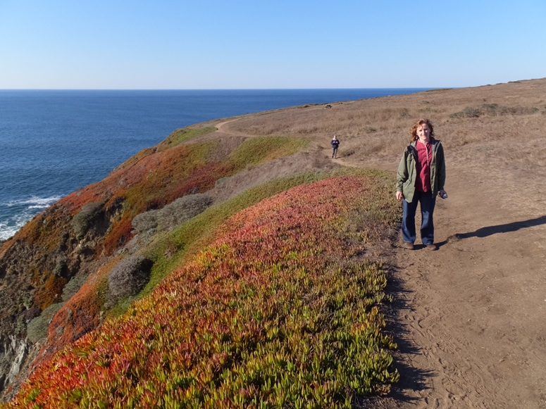 Norma with Mom behind on trail with very interesting vegetation