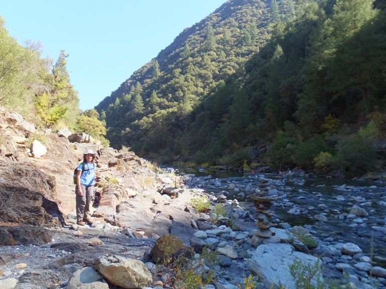 Norma walking on trail near stream