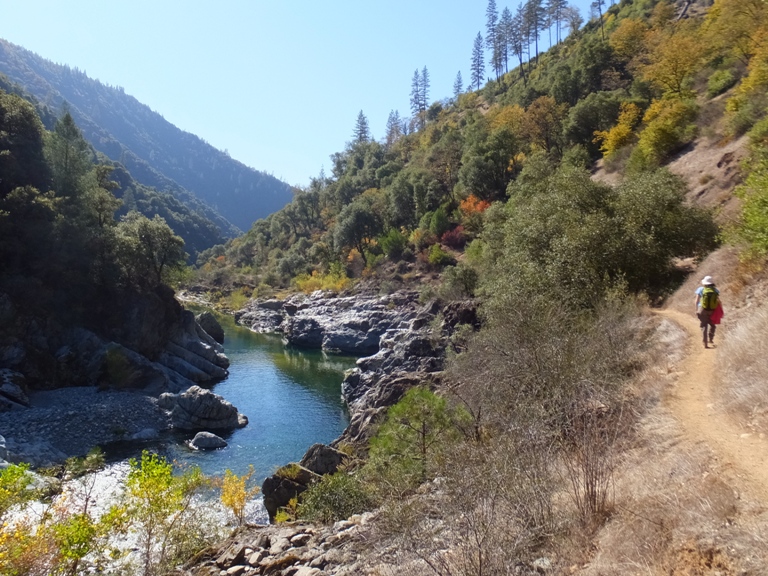 Norma standing on a rocky area next to the river