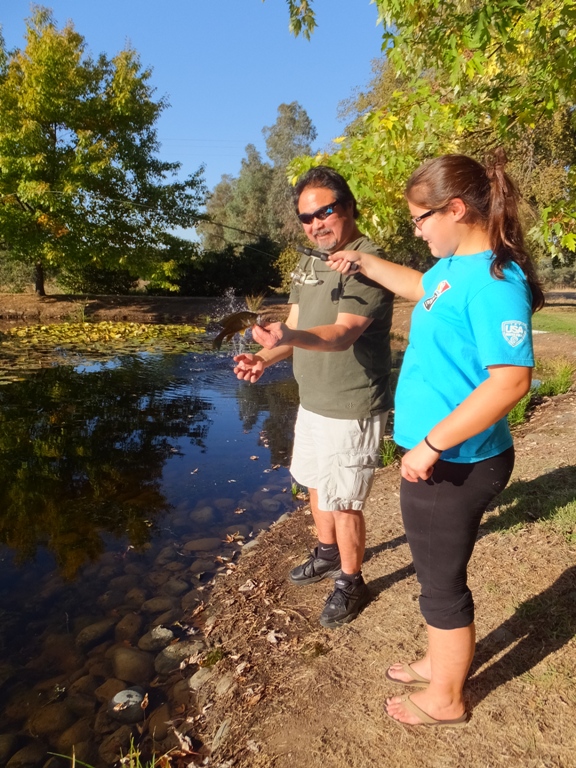 Mark and Makayla with fish on line