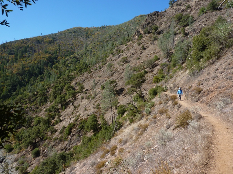 Me walking on a trail lined by dry grass