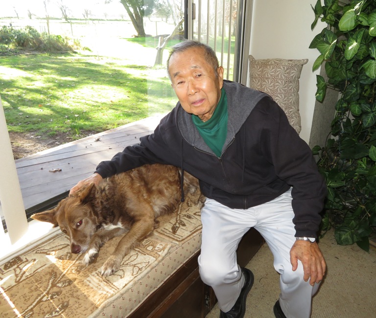 Babe on cushion with Dad adjacent