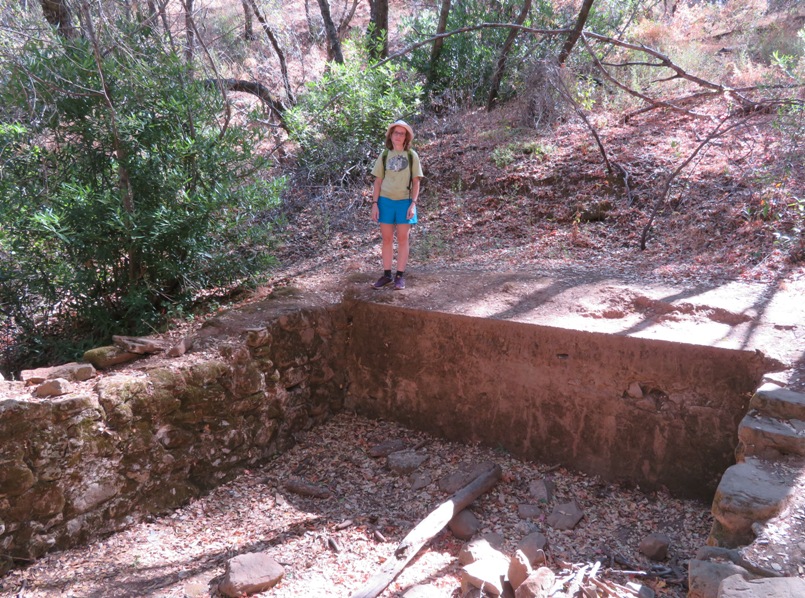 Norma standing by homestead ruins