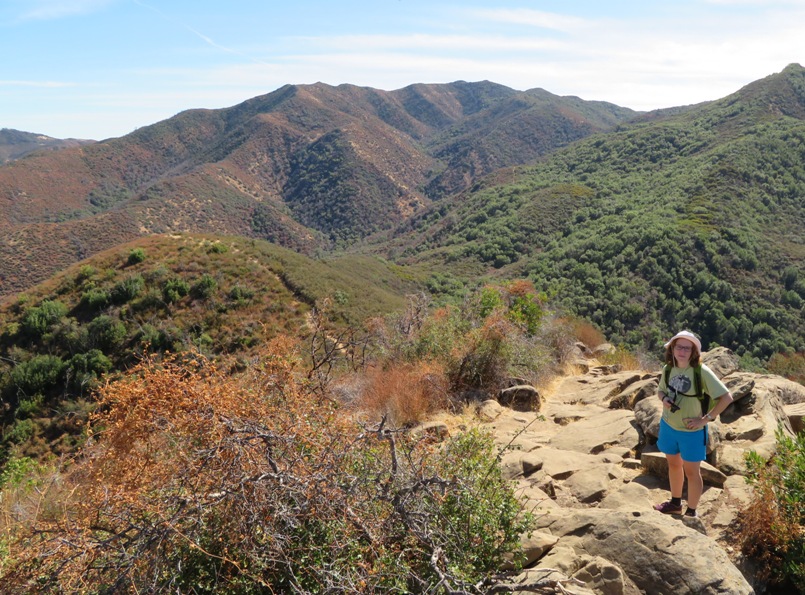 Norma standing on rocks with nice view behind