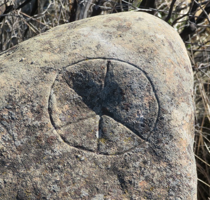 Rock carving that looks like Trivial Pursuit gamepiece