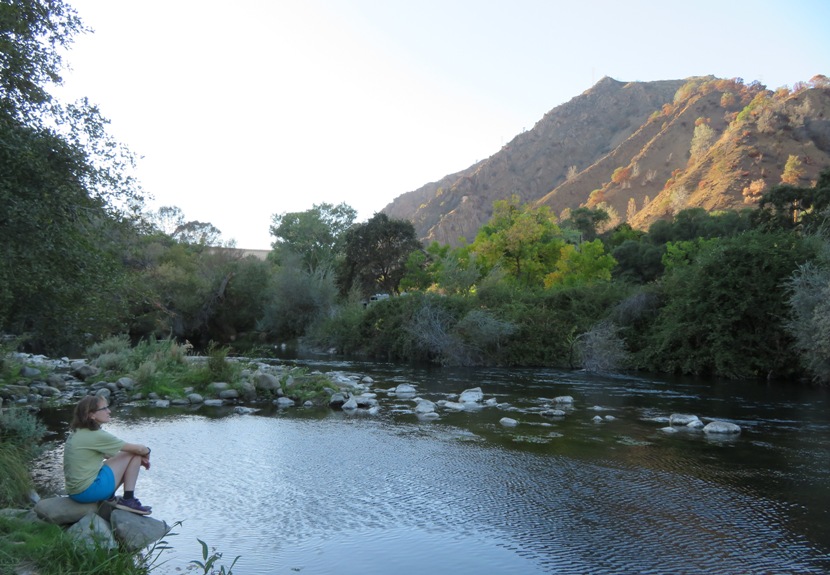 Norma sitting by Putah Creek