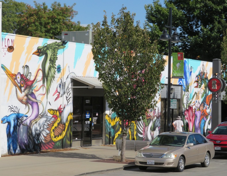 Colorful fantasy animals painted on side of building