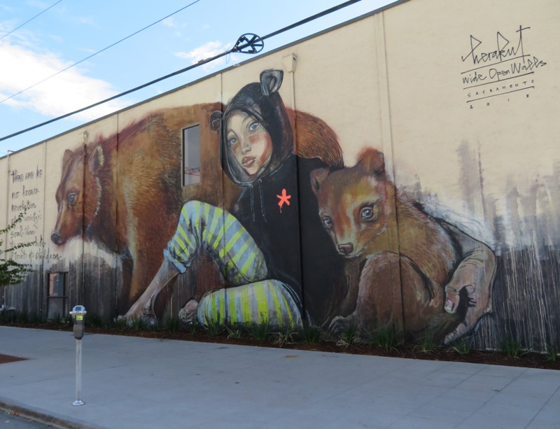 Big mural of bears of two bears and person with bear ears