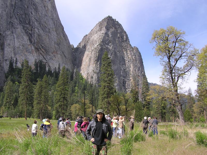 Me at a tour stop with tourists behind and tall rock formations behind them