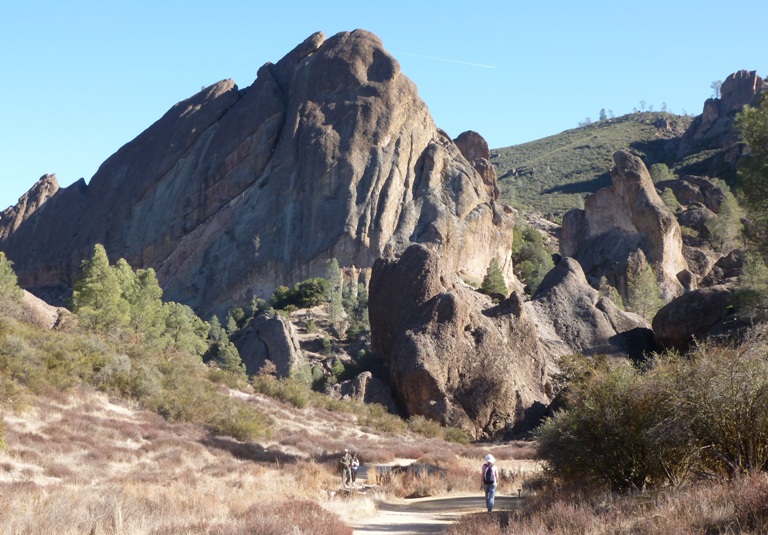 Hikers dwarfed by Balconies rocks