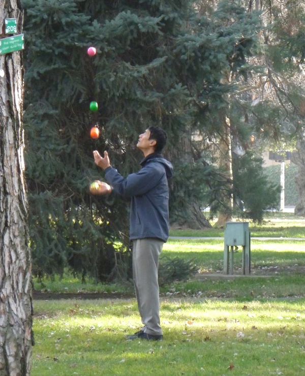 A guy juggling balls