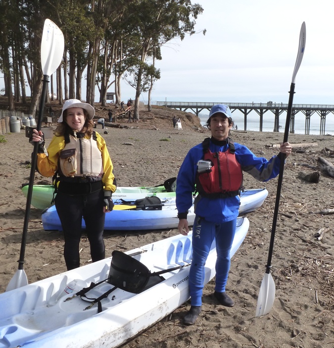 Norma and I next to kayak with paddles in hand