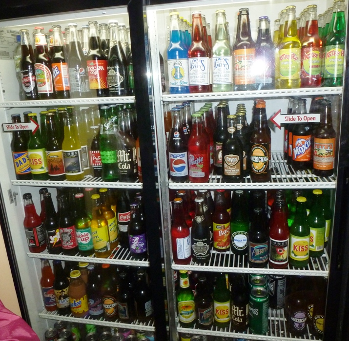 A fridge full of a variety of sodas