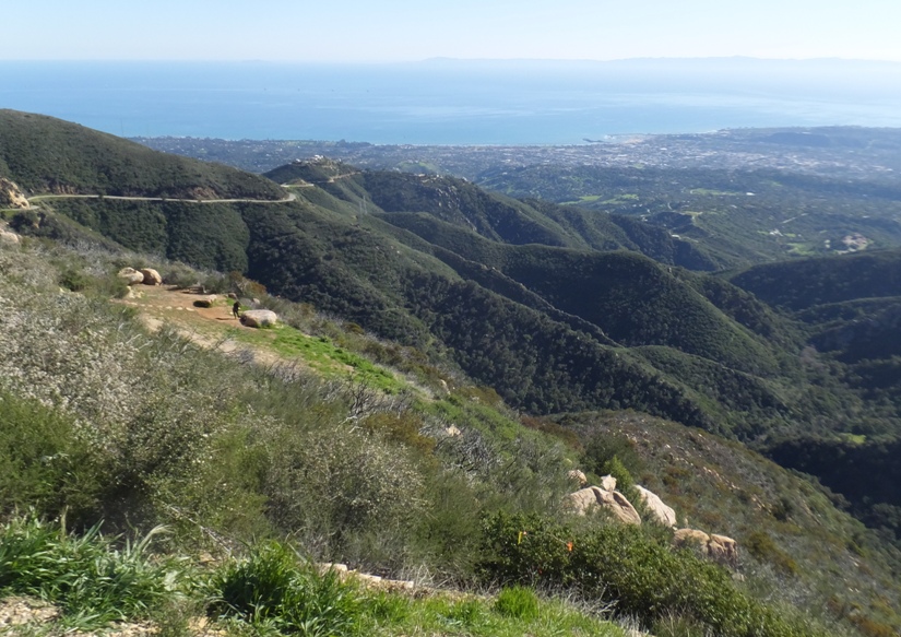 Green hills with ocean behind