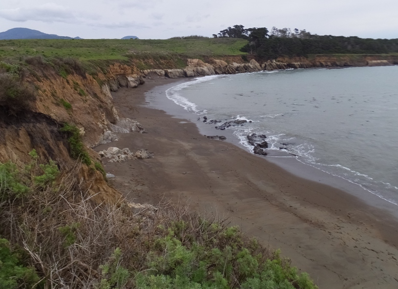 Cliff bending around the water