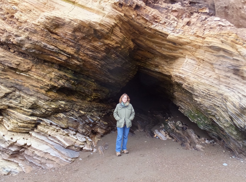 Norma at the opening of a rocky cave