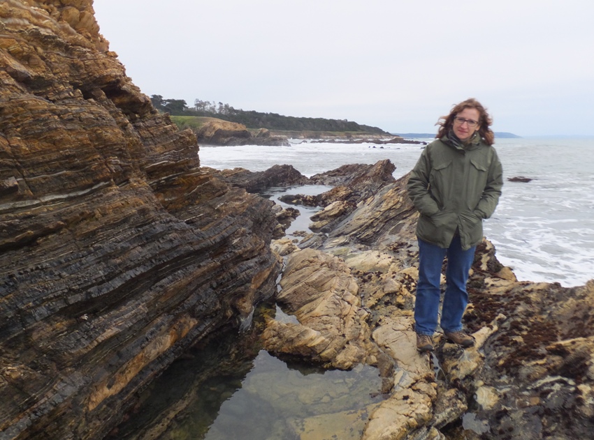 Norma standing by the tidepools