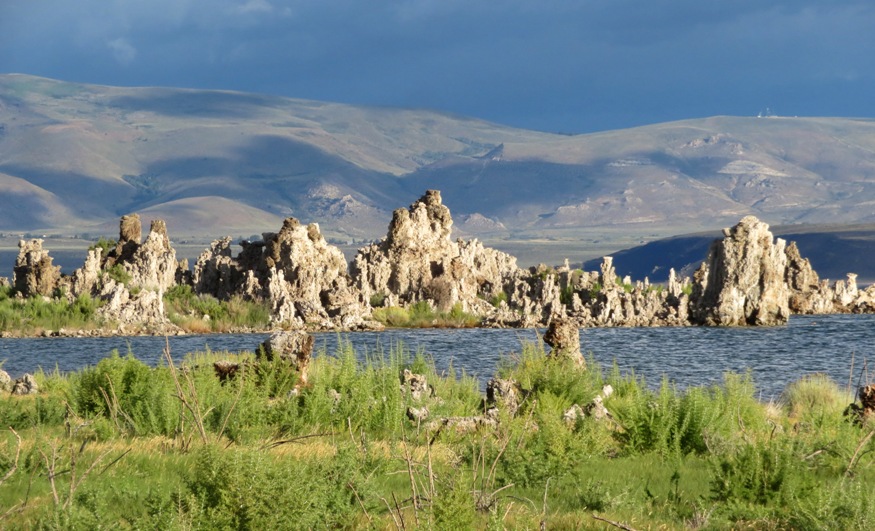 Tufas on water with shadowy mountains behind