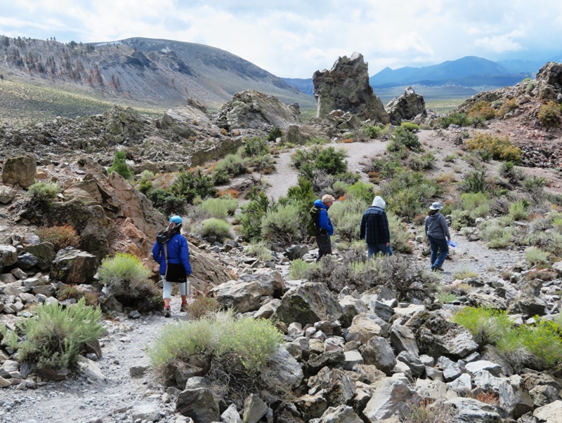 Visitors walking on stone-lined trail