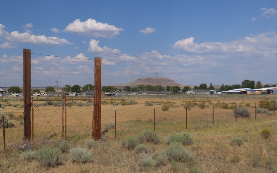 Dry field behind fence