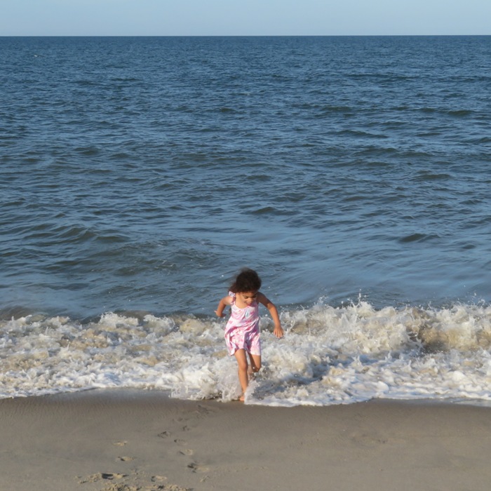 The youngest running from a small wave