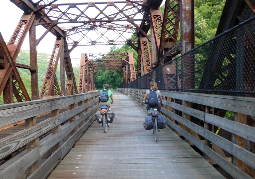 Norma and Carmen biking across old railroad bridge