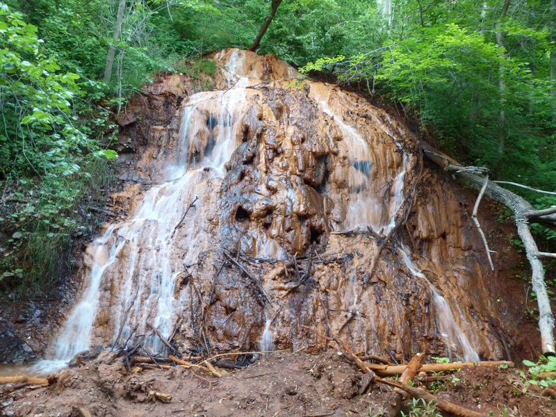 Water flowing over red rocks