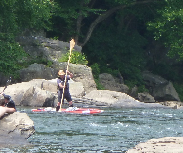 Man doing whitewater SUP